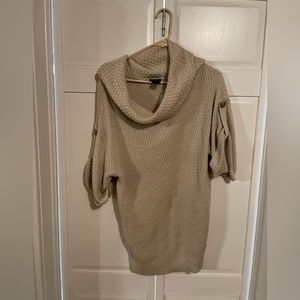 Ann Taylor slouchy turtleneck in cream, has elbow length sleeves with button.